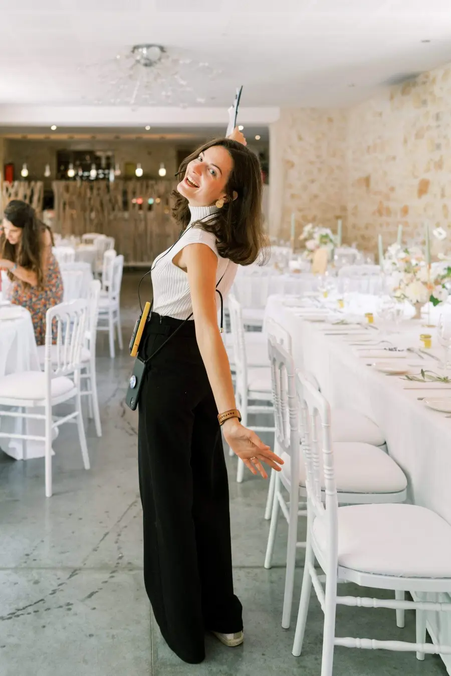 Julie Nagy coordinating a château wedding reception, headset in hand